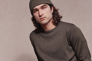 Picture of model from torso up. Model wears Asuwere Ribbed beanie in Khaki and Asuwere Cotton Silk Crew Knit Sweater in Khaki