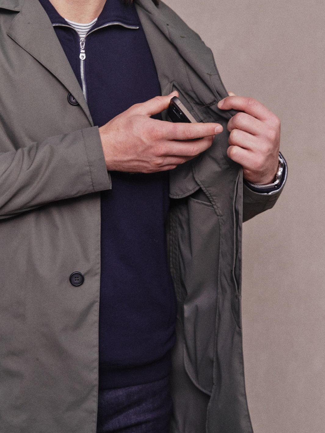 Close up of mobile phone pocket on inside chest of Rain Mac Jacket