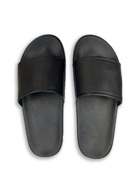 Birds eye view of Black Leather Low Slides against white background